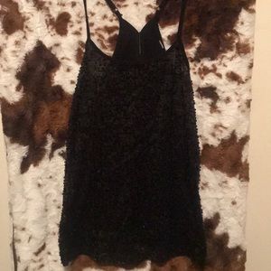 Woman’s small sheer black sequin tank top